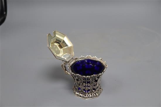 A Victorian pierced silver mustard, with flared rim and blue glass liner, J & J Angell, London, 1846, height 8cm, 4.5 oz.